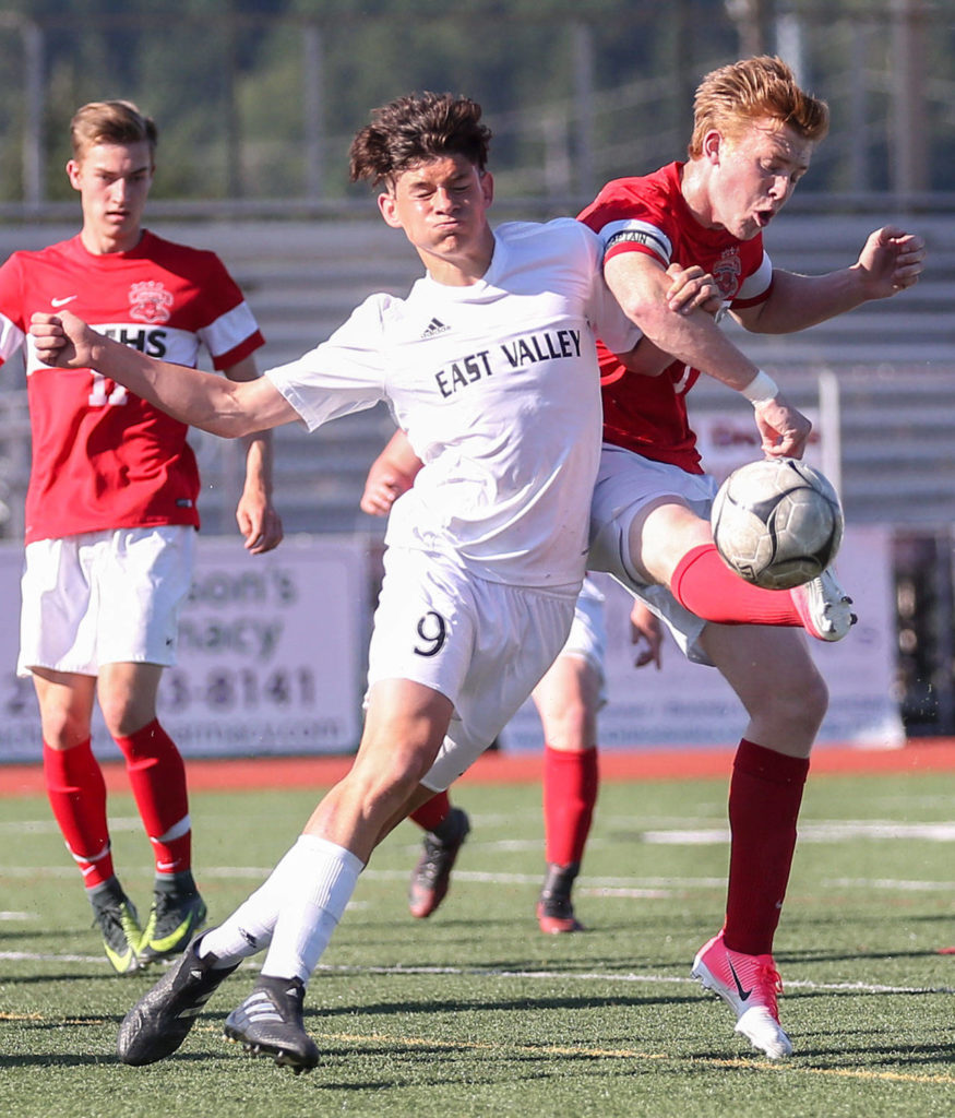 Archbishop Murphy’s Matt Williams (right) shots and scores past East Valley’s Fabian Kirby during the 2A state soccer championship match on May 27, 2017, at Sunset Chev Stadium in Sumner. (Kevin Clark / The Herald)
