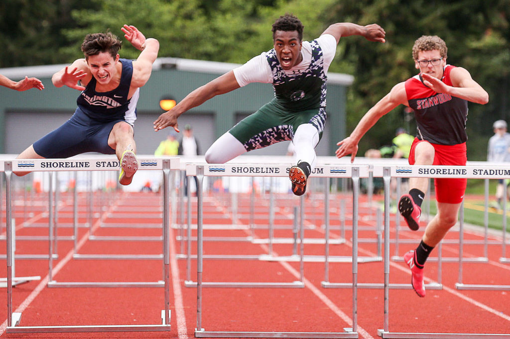 Arlington’s Campbell Hudson (left), Edmonds-Woodway’s Aaron Richardson (center) and Stanwood’s Tyler Younce compete in the 110-meter hurdles during the 3A District 1 track and field championships on May 19, 2017, at Shoreline Stadium. (Kevin Clark / The Herald)
