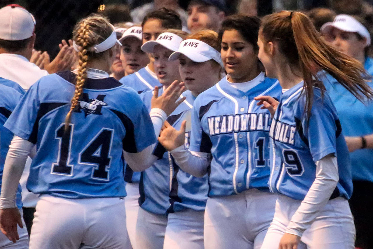 Meadowdale players congratulate each other after defeating Marysville Pilchuck in a 3A district semifinal game on May 18, 2017, at Phil Johnson Ballfields in Everett. (Kevin Clark / The Herald)