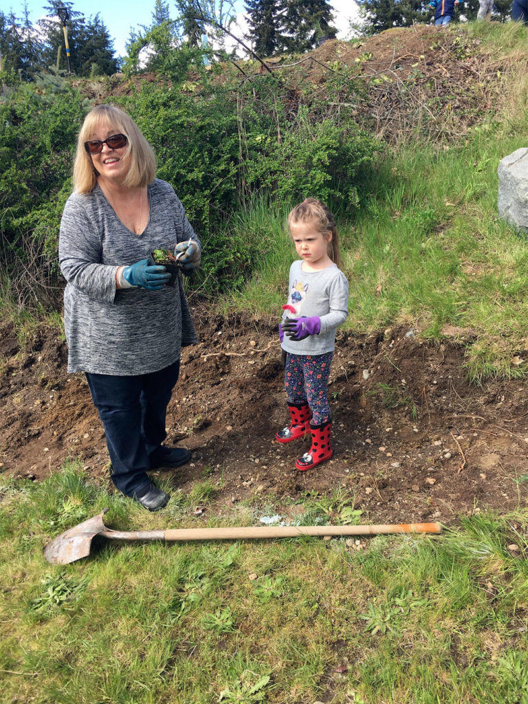 Teacher Patti Baughn and Amber Aleksich take part in a tree-planting event at Alderwood Early Childhood Center. (Contributed photo)
