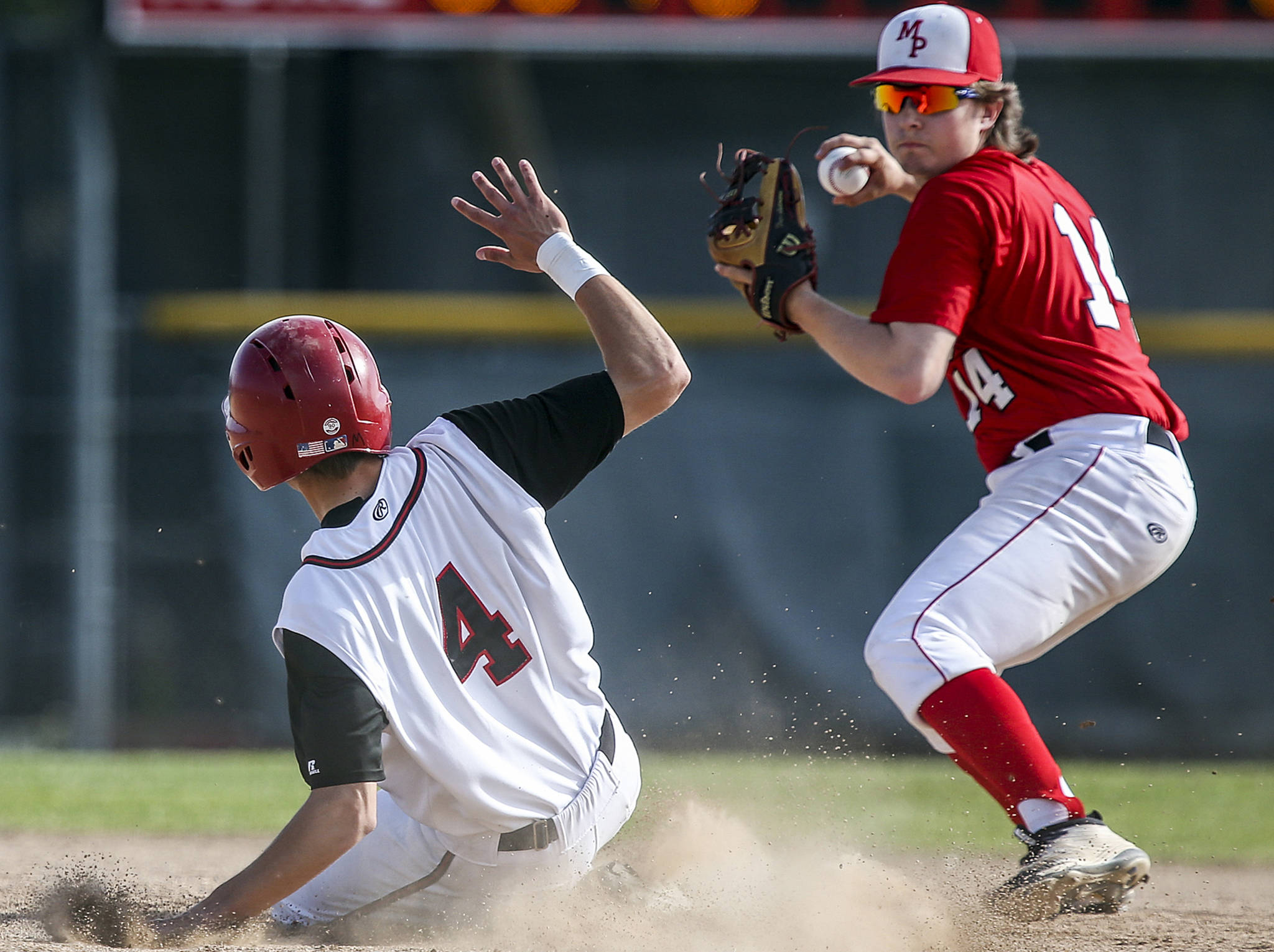 Snohomish’s Adam Ivelia is tagged out by Marysville Pilchuck’s Trevor Anderson attempting a double play at Earl Torgeson Field in Snohomish on May 10. Snohomish won 5-4. (Kevin Clark / The Herald)