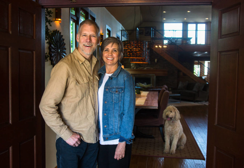 Gayle and Brent Yeadon stand at the entrance to their home, the former Mukilteo Presbyterian Church. (Daniella Beccaria / For The Herald)
