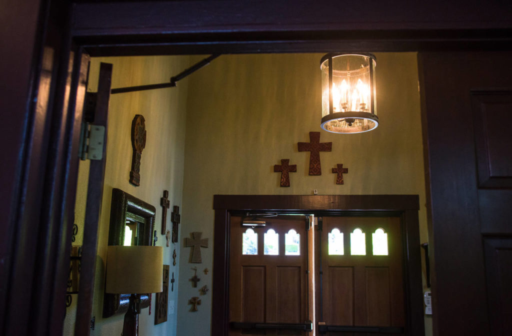 The entryway of the former Mukilteo Presbyterian Church is adorned with the Yeadons’ collection of crosses and and old-style lanterns. (Daniella Beccaria / For The Herald)
