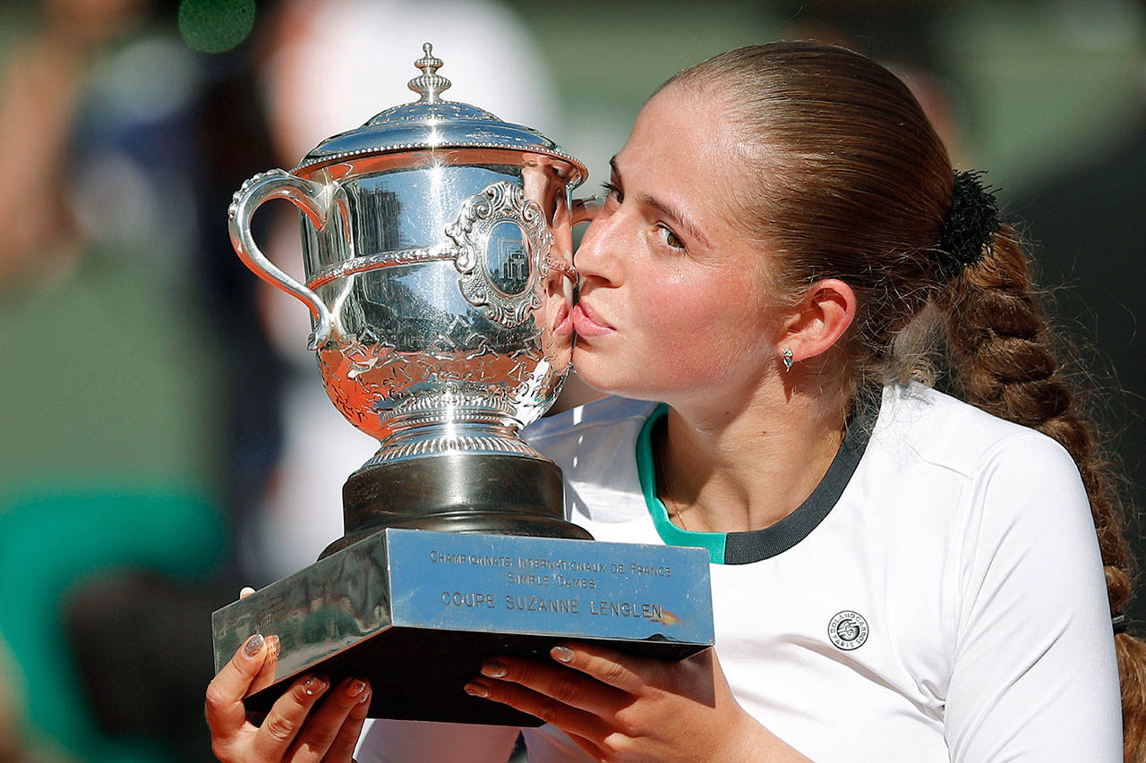 Jelena Ostapenko kisses the trophy after beating Simona Halep in three sets to win the women’s French Open singles title Saturday in Paris. Ostapenko is the first unseeded player to win at Roland Garros since 1933 and the first Latvian to win a major. (AP Photo/Christophe Ena)