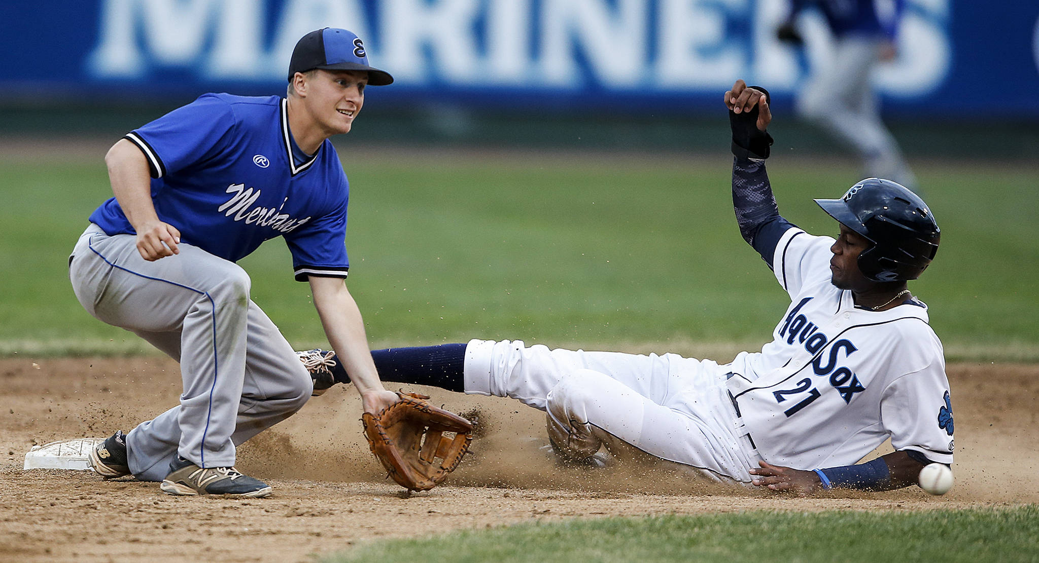 Aquasox runner Osmy Gregorio (right) slides safely into second base as Merchants second baseman Kevin Olmstead watches the ball during the Everett Cup exhibition game on June 13, 2017, at Everett Memorial Stadium. (Ian Terry / The Herald)