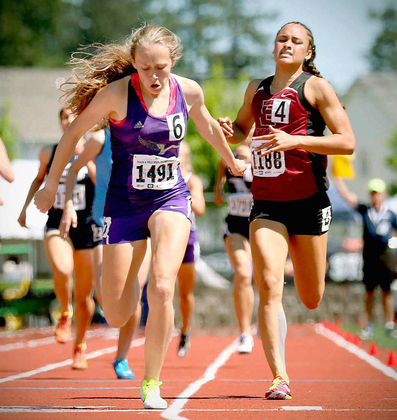 Lake Stevens’ Taylor Roe (left) edges out Eastlake’s Brooke Mason in the 800-meter final at the 4A state track championship on May 27 in Tacoma. Roe was named Washington’s Gatorade Athlete of the Year for girls track. (Kevin Clark / The Herald)