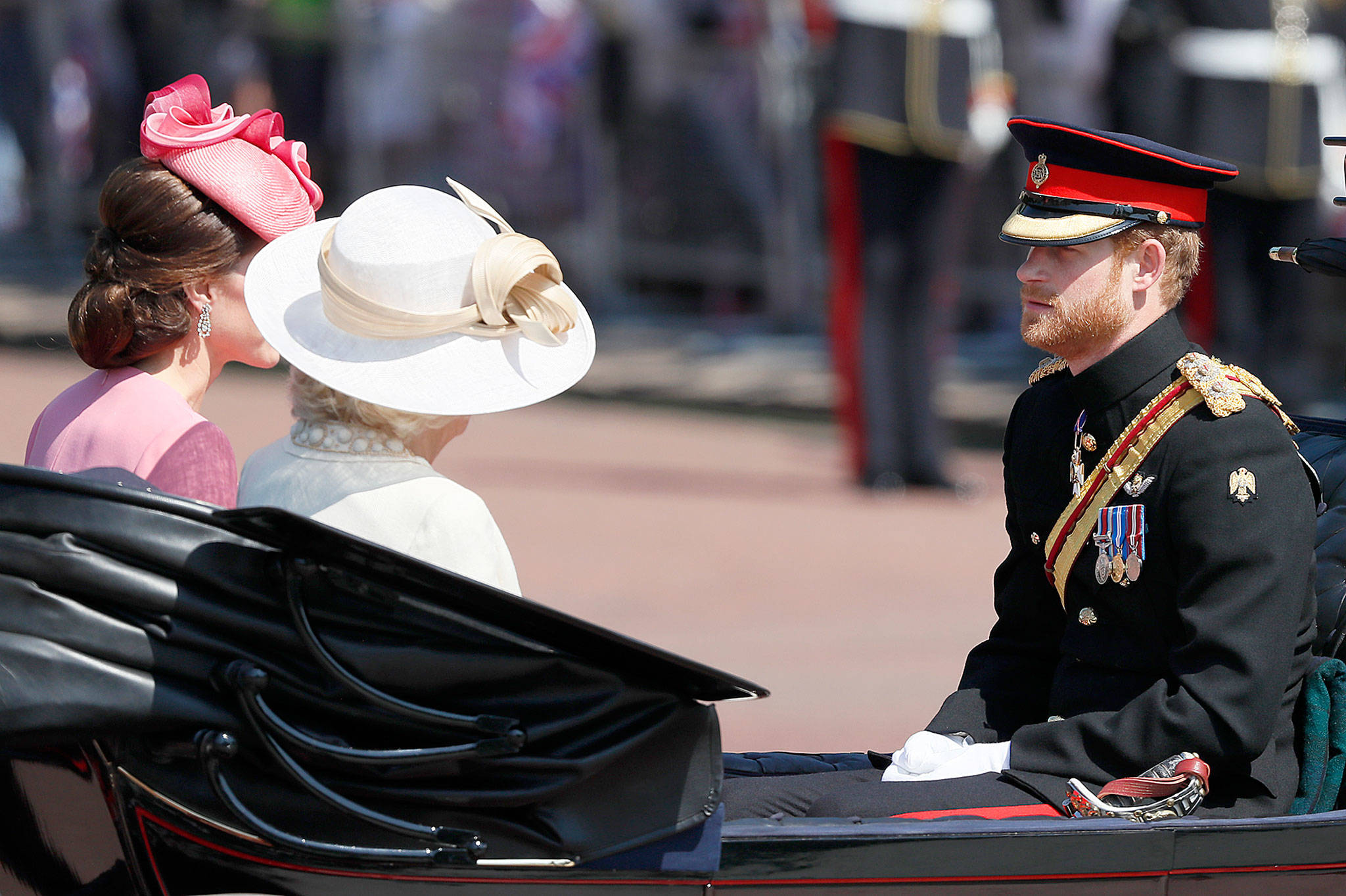 Britain’s Prince Harry (right), leaves Buckingham Palace in a carriage with Britain’s Camilla, The Duchess of Cornwall, and Kate, The Duchess of Cambridge, to attend the annual Trooping the Colour Ceremony in London on June 17. (AP Photo/Kirsty Wigglesworth)