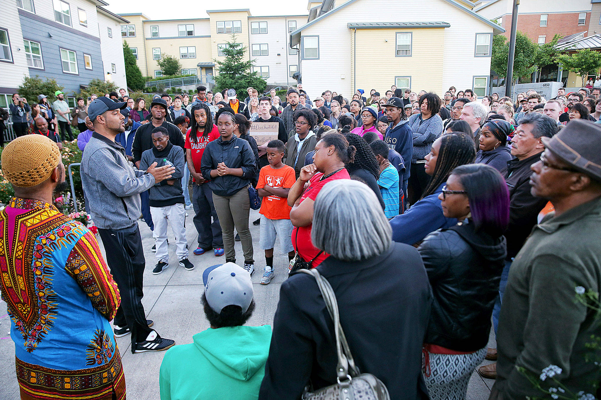 Local high school teacher and activist Jesse Hagopian speaks to people at a vigil outside the apartment building of Charleena Lyles, a 30-year-old woman who was shot by police after she called them to respond to an attempted burglary on Sunday. (Genna Martin/seattlepi.com via AP)