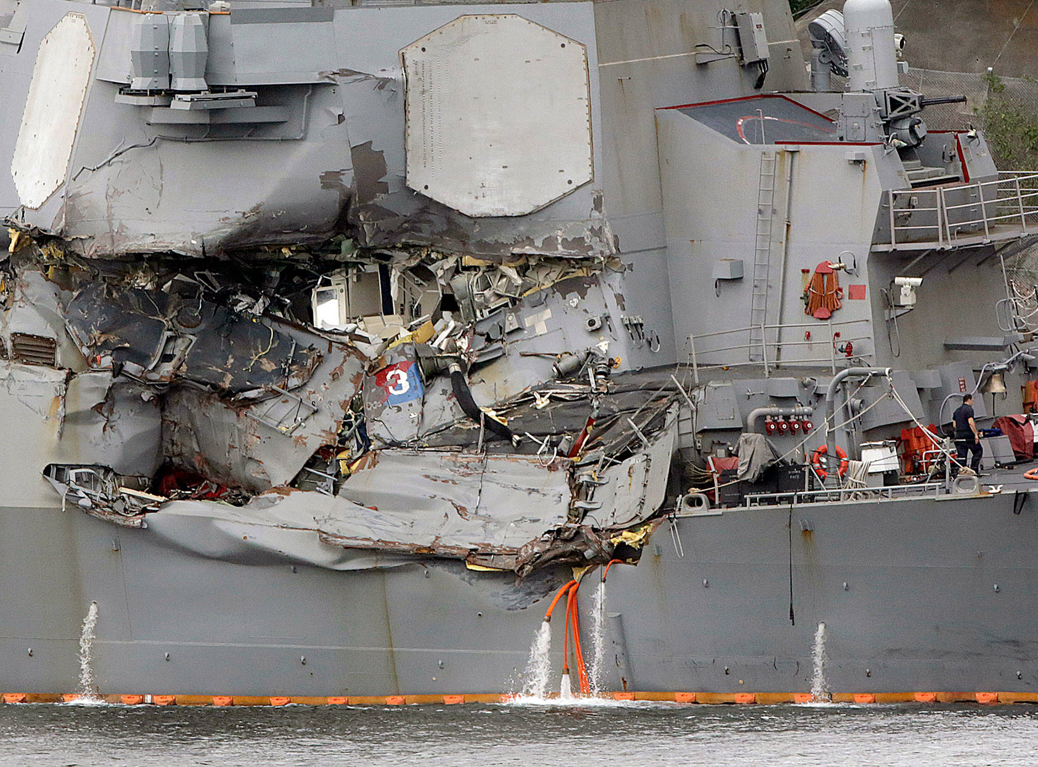 The damaged section of the USS Fitzgerald is seen at the U.S. Naval base in Yokosuka, southwest of Tokyo. (AP Photo/Eugene Hoshiko, File)