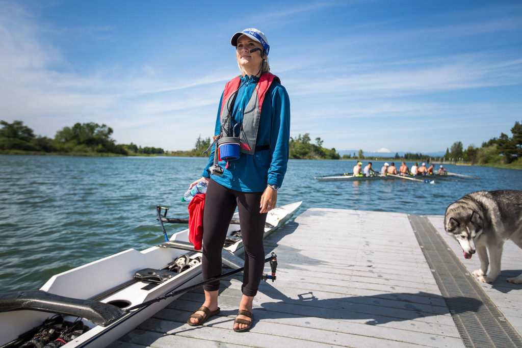 Everett Rowing Association coxswain Summer Keyes uses her leg to hold a boat next to a dock for her teammates after a rowing practice Monday in Everett. Keyes and the boys lightweight eight plus coxswain boat will be competing at the 2017 Youth National Championships beginning Friday in Sarasota, Florida. (Andy Bronson / The Herald)
