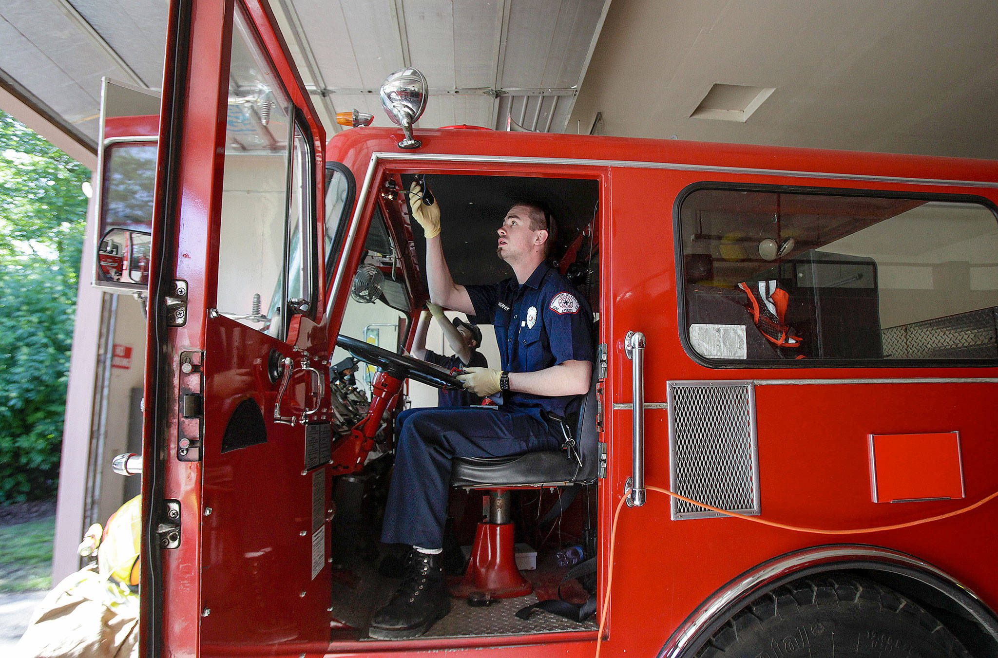 Volunteer firefighter Scott Murphy, of Federal Way, goes through a rig check in 2012 on Hat Island. The Hat Island fire department is entirely staffed by volunteers. The rigs in the fleet date back to the 1980s and earlier. Soon they are getting a 1991 model, formerly used in Machias. (Herald file)