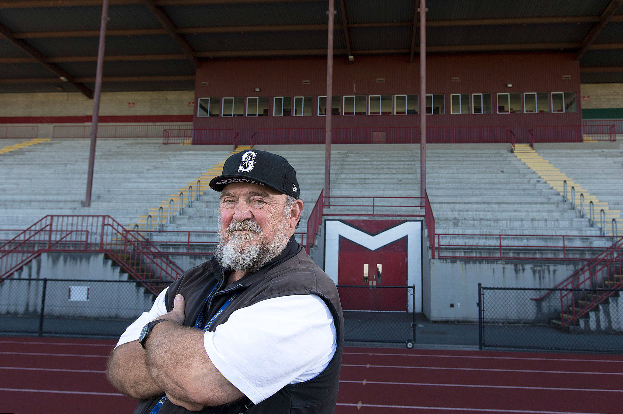 Longtime Marysville School District teacher and coach Mike VanDaveer, who also announced Marysville Pilchuck football games, poses at Quil Ceda Stadium on June 23 in Marysville. VanDaveer is retiring after more than three decades serving the Marysville community. (Andy Bronson / The Herald)