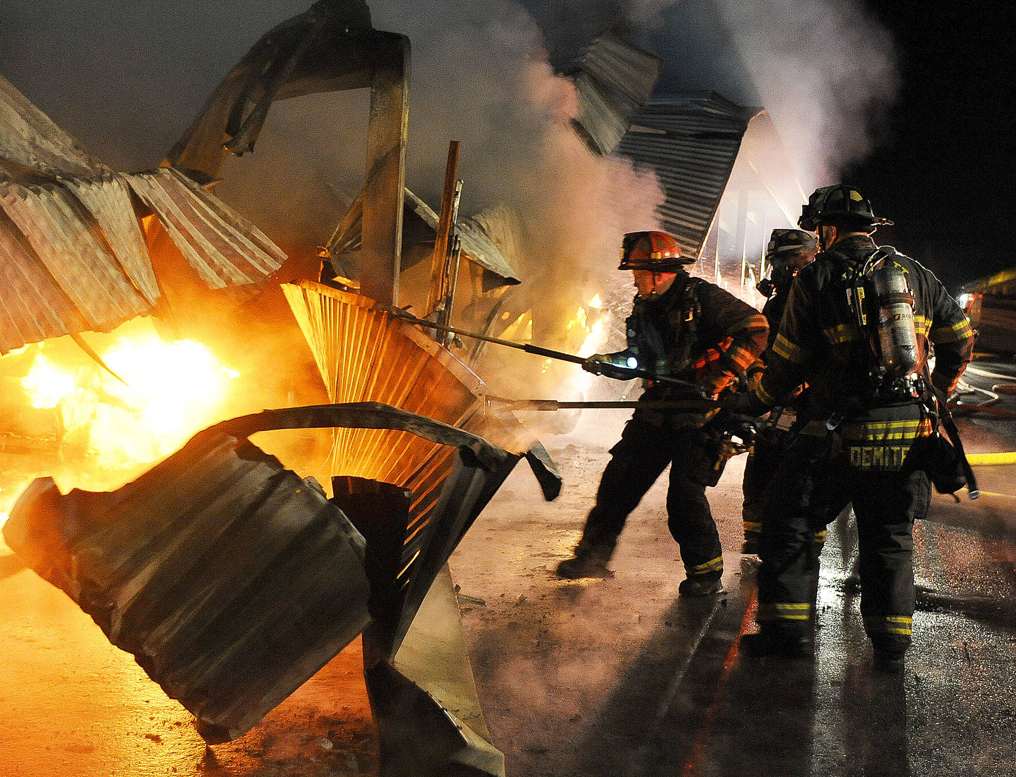 Everett firefighters from Ladder 1 work to extinguish a fire at the Snohomish Storage on Bickford on April 20. Investigators say they may never know the cause of the fire. (Doug Ramsay / For The Herald, file)