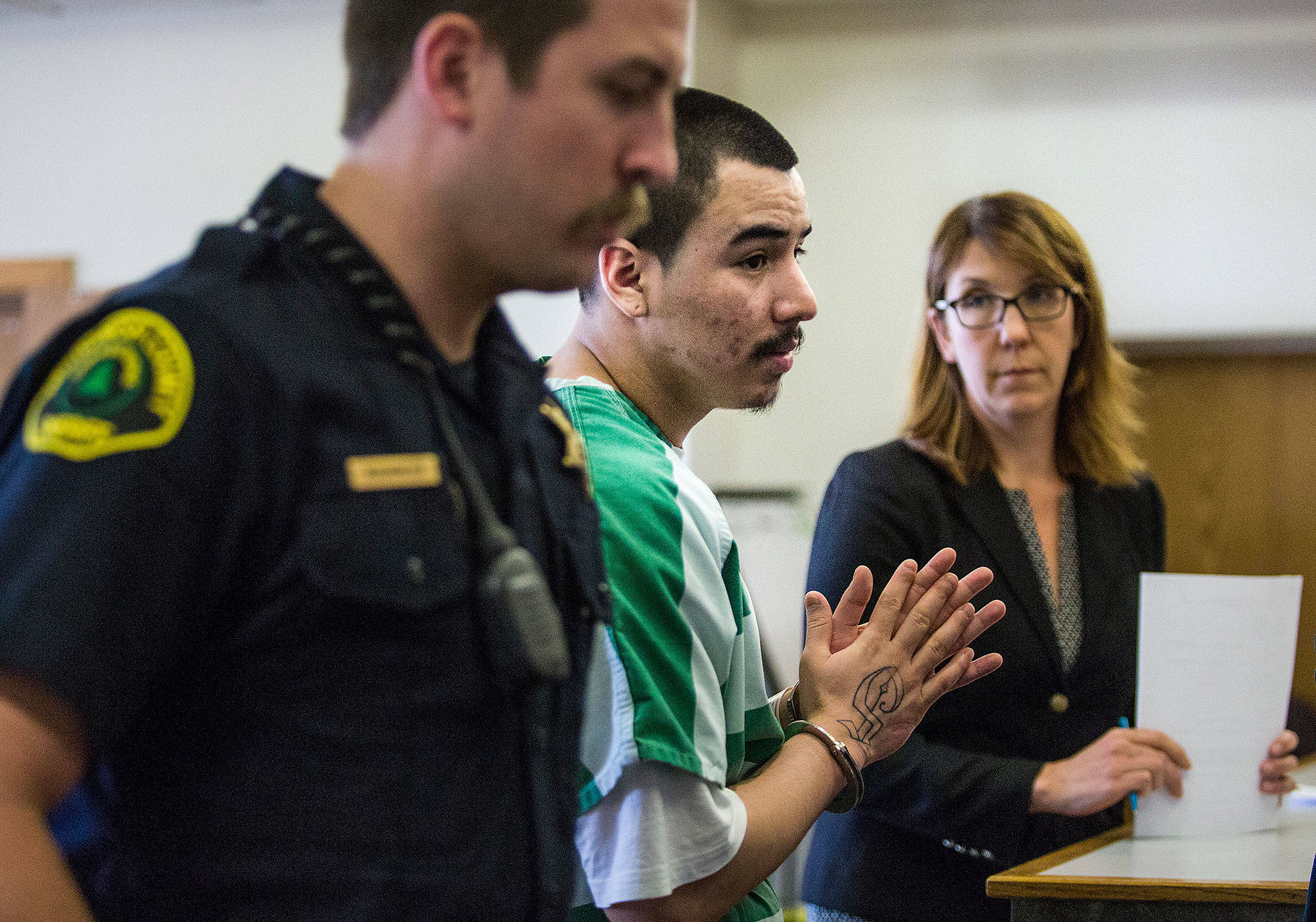 As his public defender looks on at the Snohomish County Courthouse in Everett on Tuesday, Diego Tavares is led from the courtroom after being sentenced to 25 years in prison for the 2015 murder of 17-year-old Anthony Camacho. (Andy Bronson / The Herald)