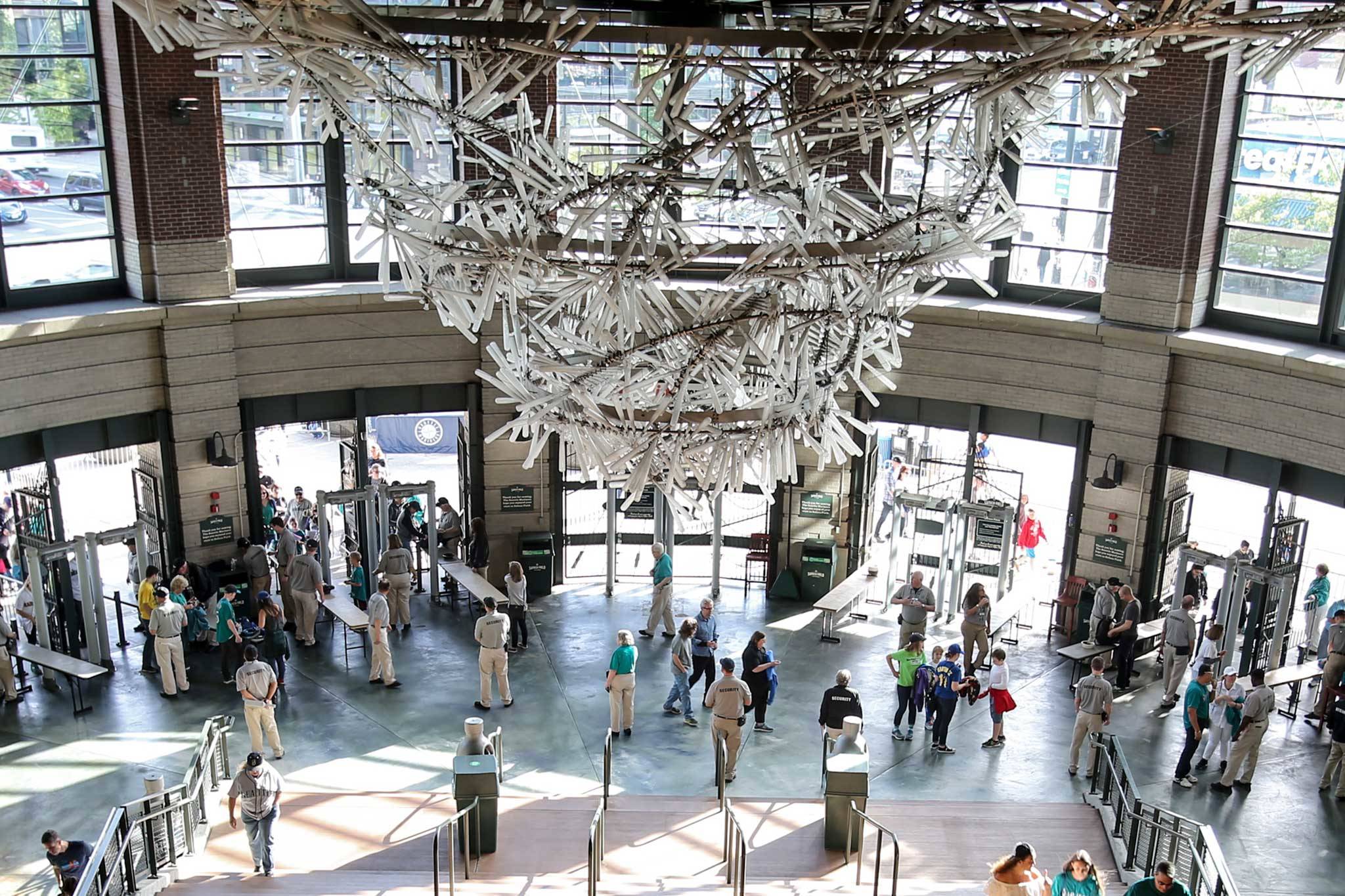 A chandelier of 1,000 bats — “The Tempest” — lords over the rotunda of home plate gate at Safeco Field. (Kevin Clark / The Herald)