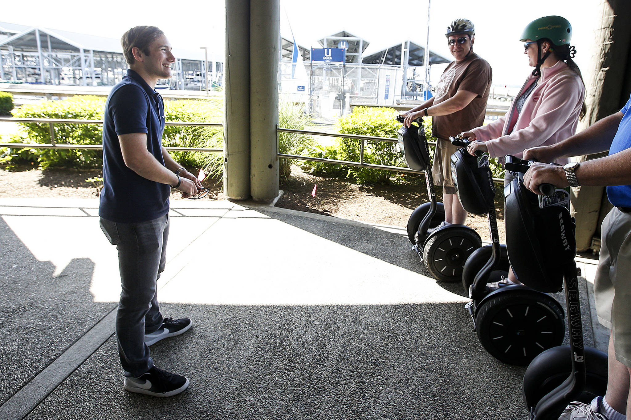 Gregg Jantz Jr. (left) goes through a few tips with Segway riders before they head out to explore the Edmonds waterfront. Jantz founded Edmonds Segway Tours five years ago when he was just 12 years old. (Ian Terry / The Herald)
