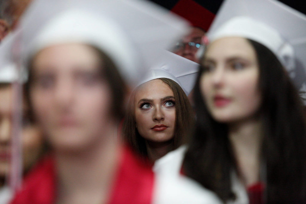 A Snohomish High senior scans the arena before the start of her graduation ceremony at Xfinity Arena on Monday in Everett. (Andy Bronson / The Herald)
