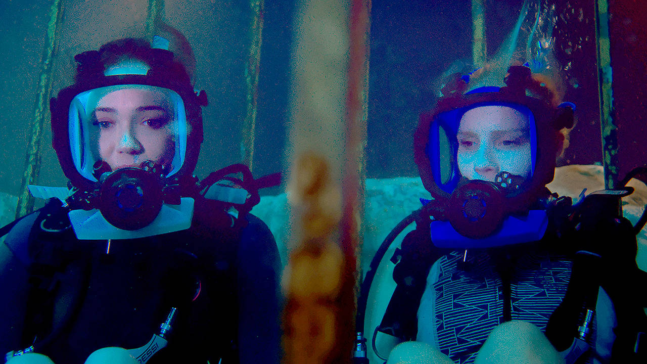 Mandy Moore (left) and Claire Holt play two sisters vacationing in Mexico who become trapped in a shark cage at the bottom of the ocean in “47 Meters Down.” (Entertainment Studios Motion Pictures)