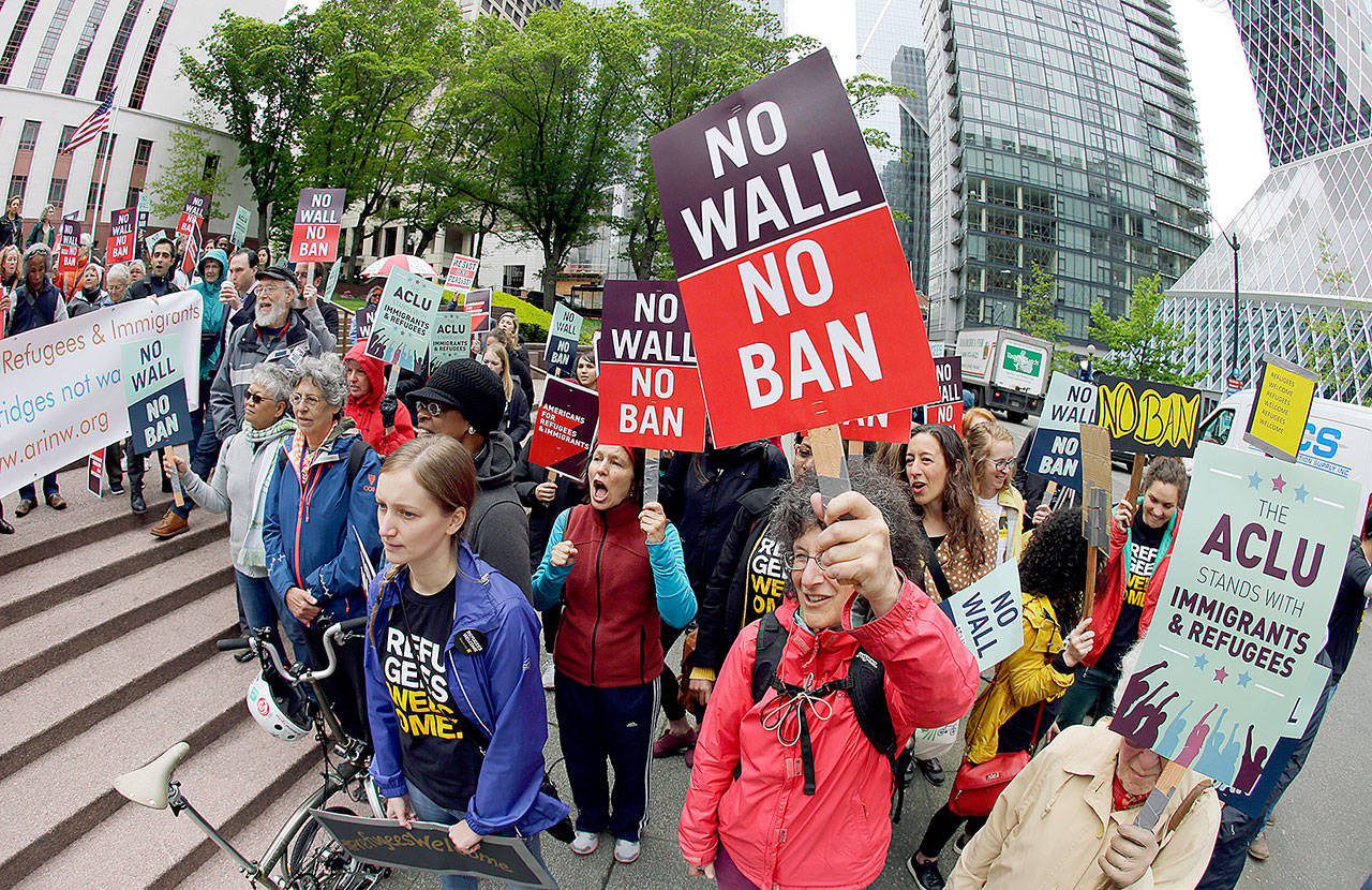 Protesters demonstrate against President Donald Trump’s revised travel ban on May 15 outside the federal courthouse in Seattle. (AP Photo/Ted S. Warren)