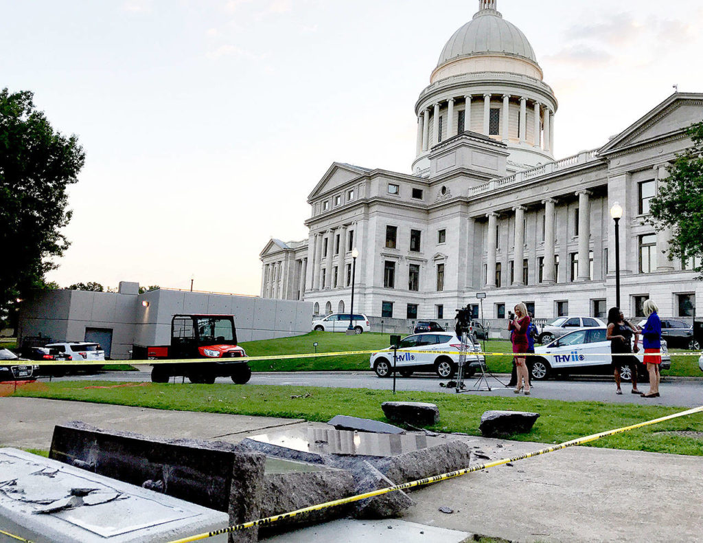 The new Ten Commandments monument outside the state Capitol in Little Rock, Arkansas, is blocked off Wednesday morning after someone crashed into it with a vehicle, less than 24 hours after the privately funded monument was erected. (AP Photo/Jill Zeman Bleed)
