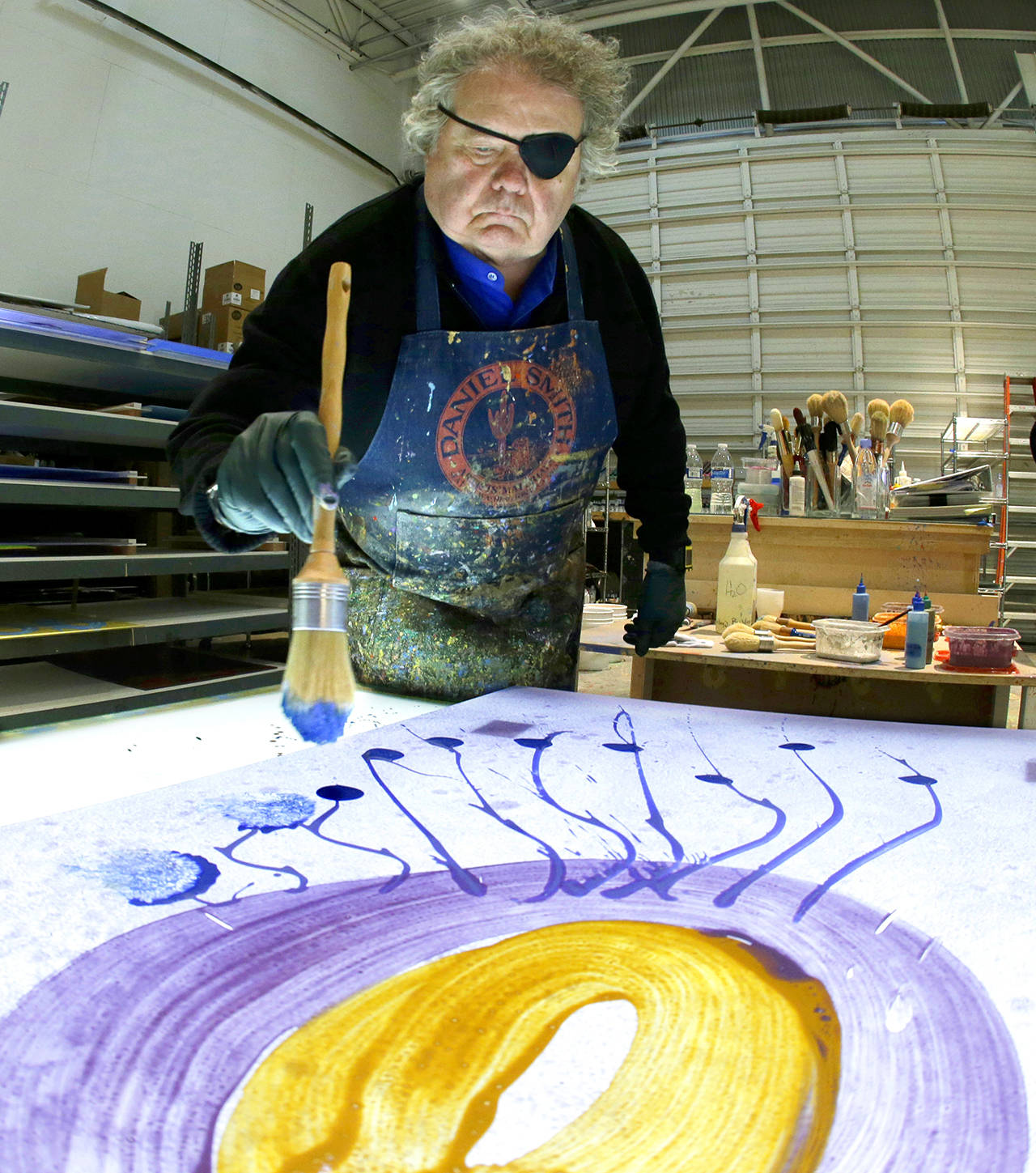 In this March 23 photo, glass artist Dale Chihuly works on a piece titled, “Glass on Glass,” in one of his studios in Seattle. (AP Photo/Ted S. Warren)