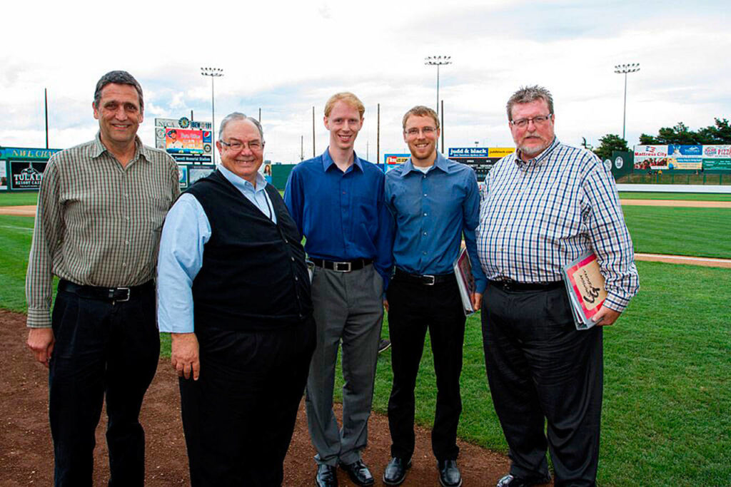 Pat Castro (second from left) leads the choir group Common Ground, pictured here after singing at an AquaSox game. (Submitted photo)
