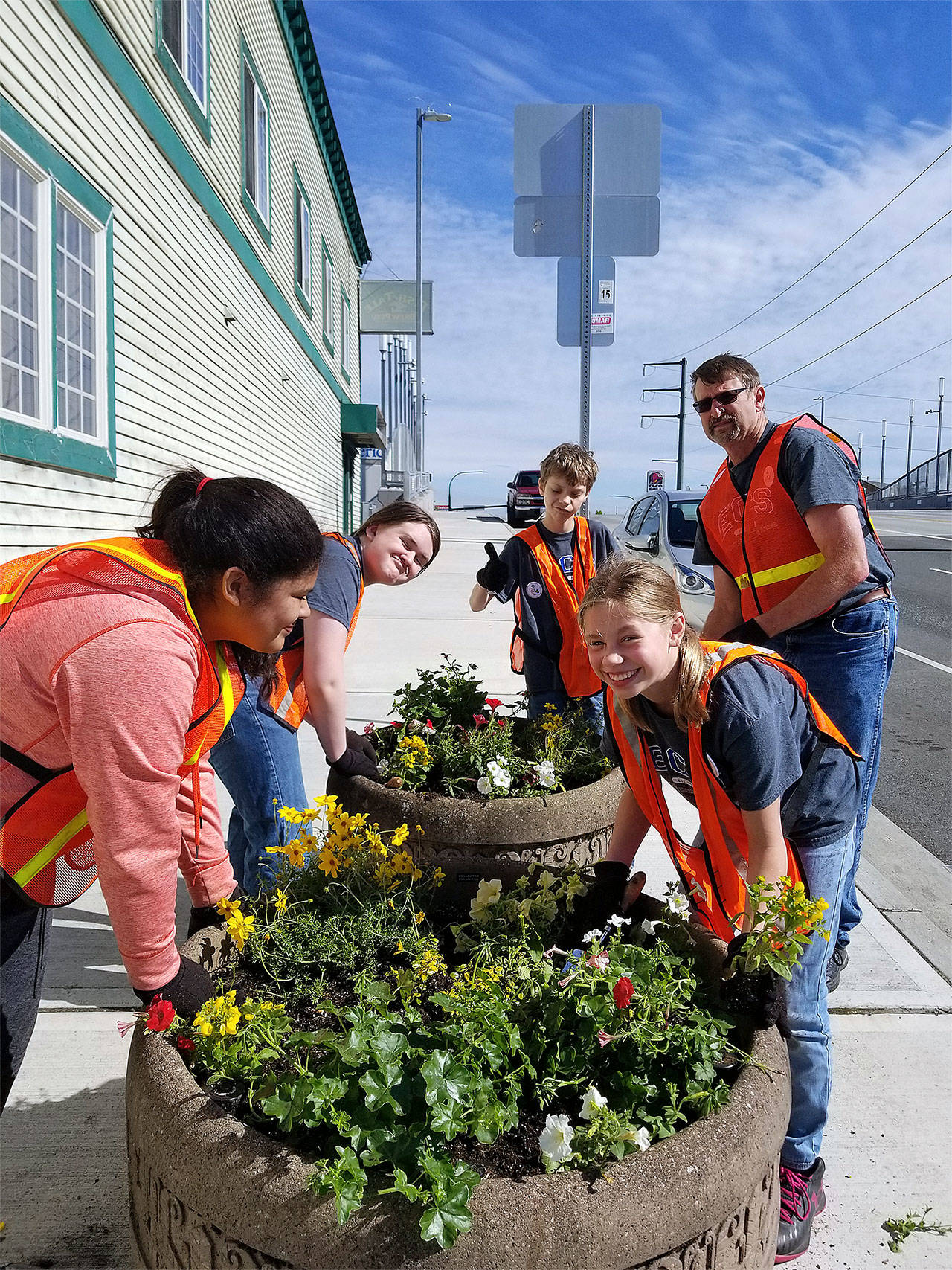 Everett Christian School students (from left) Audriel Hays, Alex Bird, Logan Hoerster and Peyton Lathrop with teacher Dan Davelaar help plant flowers May 19 in downtown Everett as part of the school’s Serve-a-Thon. (Contributed photo)