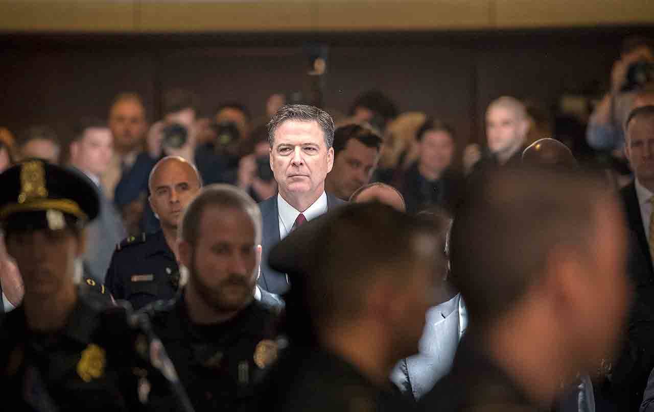 Former FBI director James Comey walks through a corridor on the way to a secure room to continue his testimony to the Senate Select Committee on Intelligence on Capitol Hill in Washington on Thursday. (AP Photo/J. Scott Applewhite)