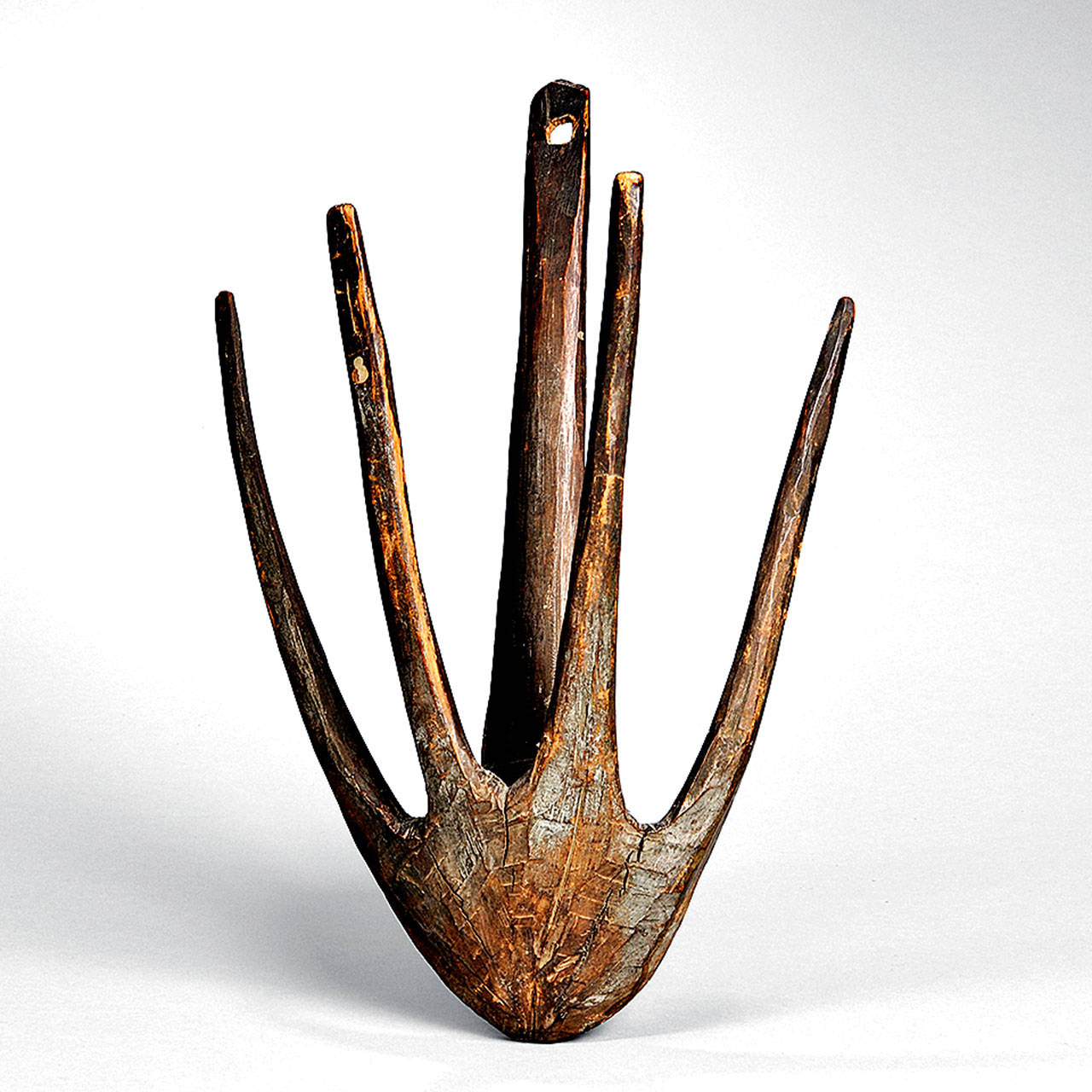 This strange wooden carving is an early drying rack that was handmade from a single branch. Collectors of primitive pieces bid it up to $6,500. It is 17 inches high and 11 inches wide. (Cowles Syndicate Inc.)