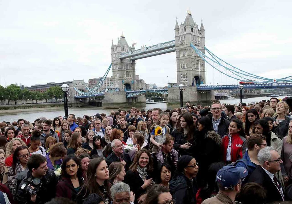 At Potter’s Field Park in London on Monday, people attend a vigil for victims of Saturday’s attack on London Bridge. (AP Photo/Tim Ireland) 
