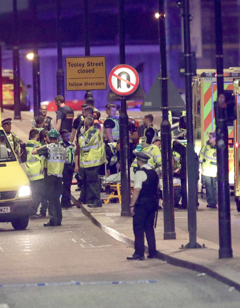 Emergency personnel tend to the wounded on London Bridge on Saturday. (Dominic Lipinski / PA)
