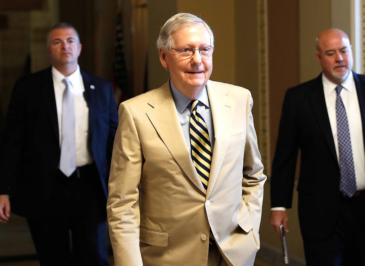 Senate Majority Leader Mitch McConnell of Kentucky walks from his office on Capitol Hill in Washington on Monday. Senate Republicans unveil a revised health care bill in hopes of securing support from wavering GOP lawmakers. (AP Photo/Carolyn Kaster)