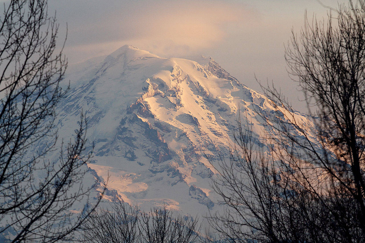 Mount Rainier at dusk in January 2012. Interior Secretary Ryan Zinke says he’ll ease the impact of potentially huge National Park Service budget cuts by shifting more resources to the “front line,” but offers little detail. (Ellen M. Banner/Seattle Times/TNS)