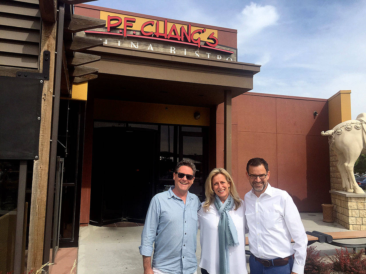 Winemaker John Freeman stands with Mary Melton of P.F. Chang’s and Precept CEO Andrew Browne in front of P.F. Chang’s China Bistro in Kennewick, Washington. (Andy Perdue/Great Northwest Wine)
