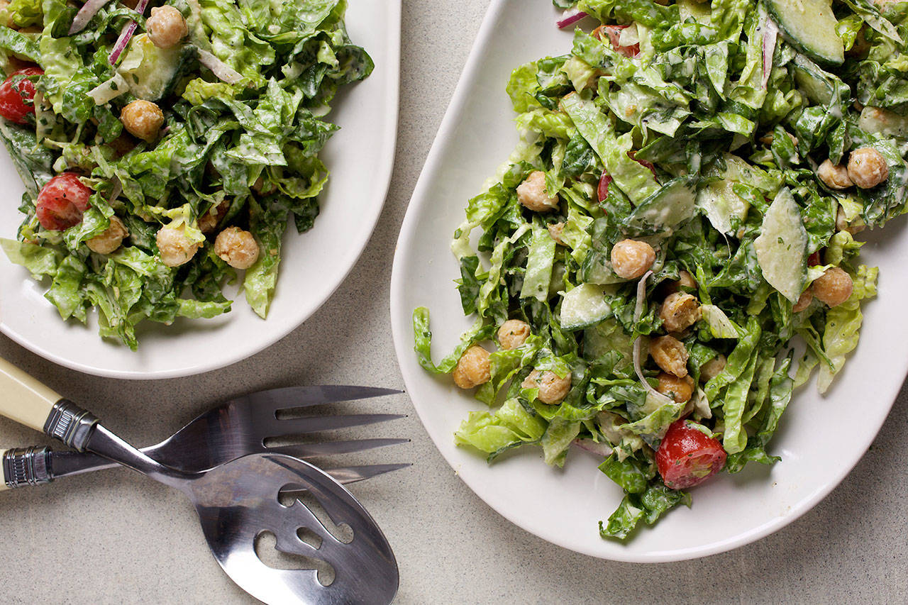 This salad gets its inspiration from the elements that fill a falafel sandwich. It is topped with crispy, spiced chickpeas and a tahini dressing. (Photo by Deb Lindsey for The Washington Post)