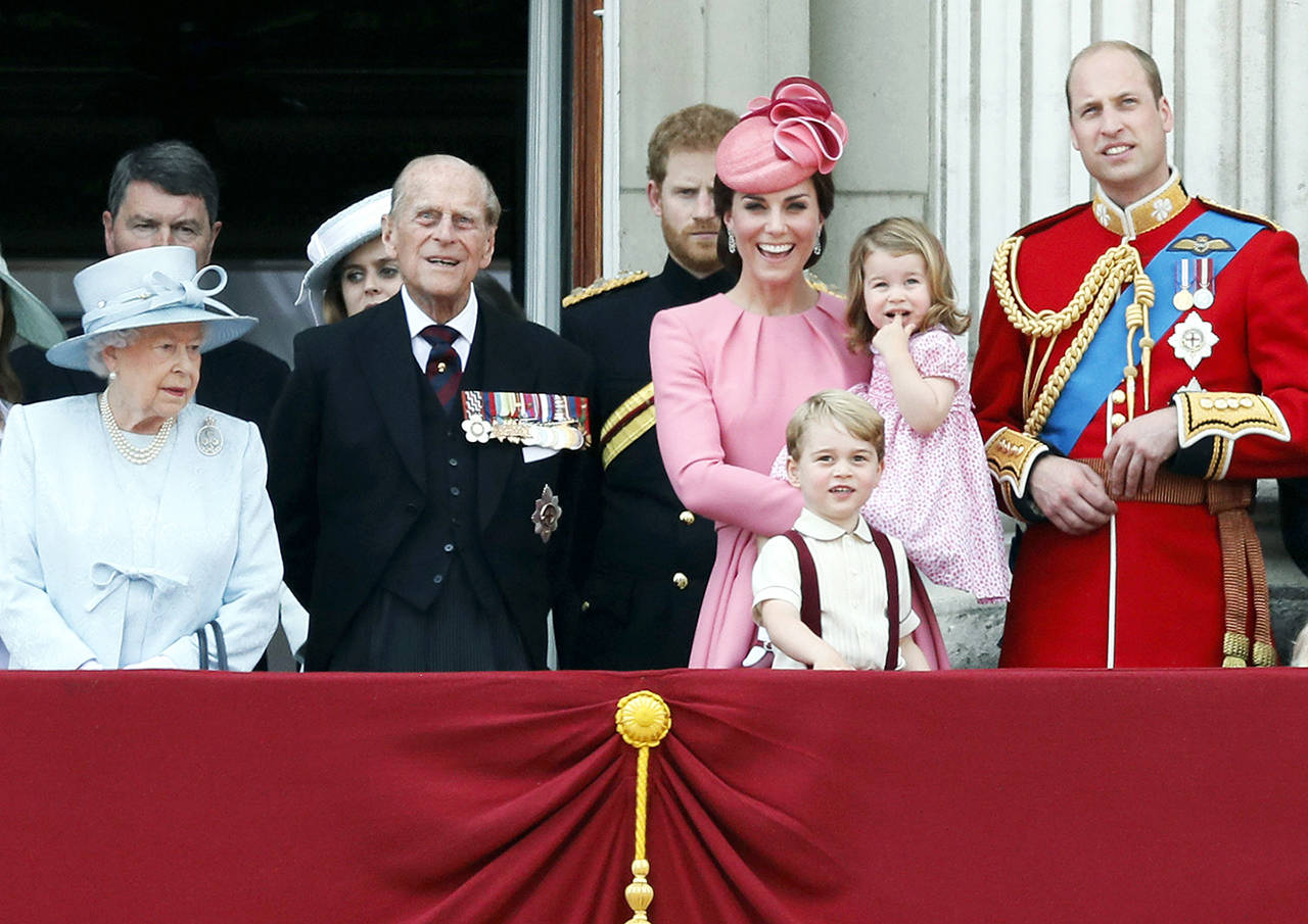 In this June 17 photo, members of the British royal family with (from left) Queen Elizabeth II, Prince Philip, Prince Harry, Princess Kate, The Duchess of Cambridge with children Prince George and Princess Charlotte, and Prince William gather on the balcony of Buckingham Palace. (AP Photo/Kirsty Wigglesworth, FILE)