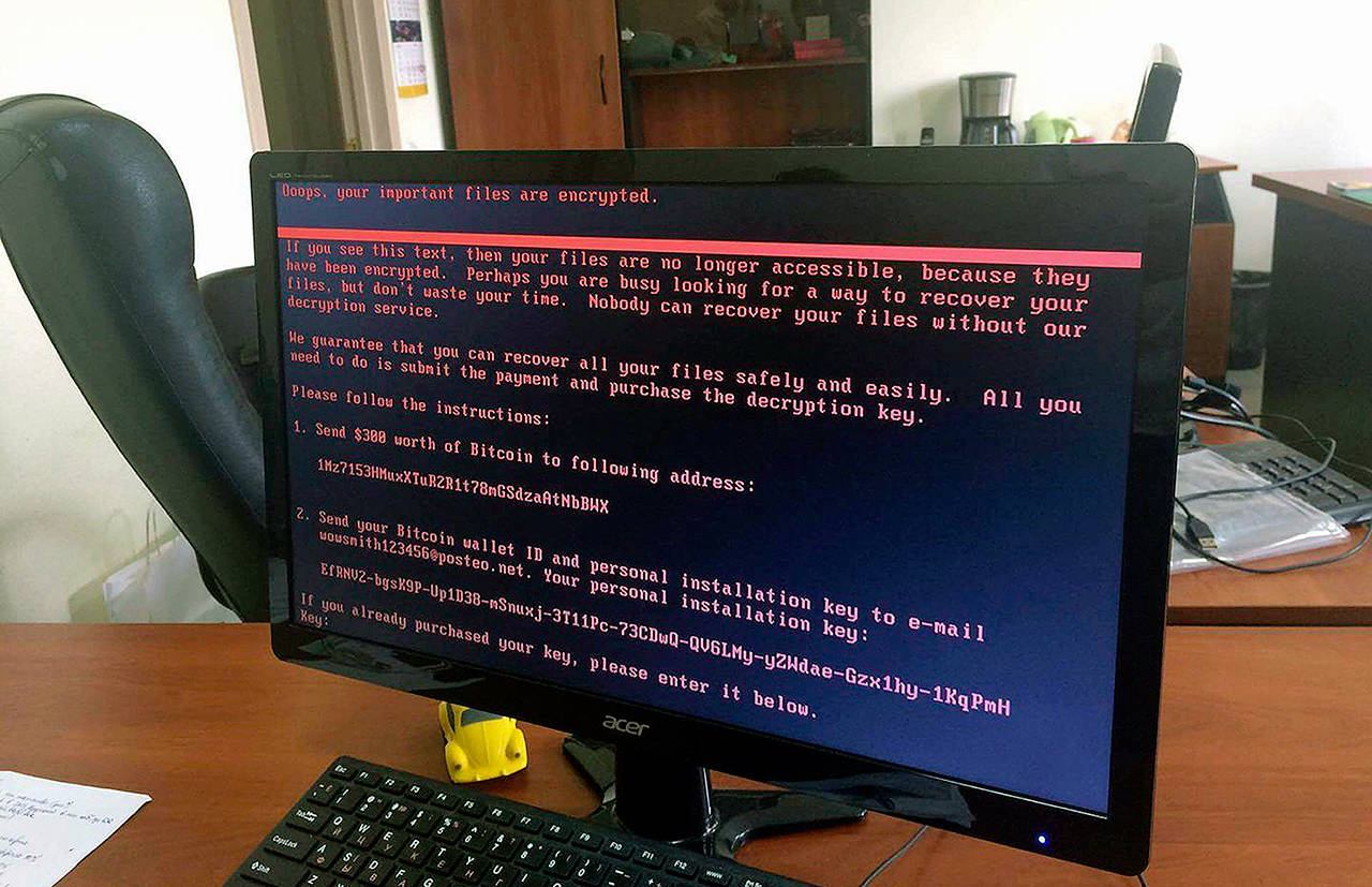 A computer screen at an office in Kiev, Ukraine, shows a warning notice demanding ransom, part of a massive international cyberattack on Tuesday. (Oleg Reshetnyak via AP)