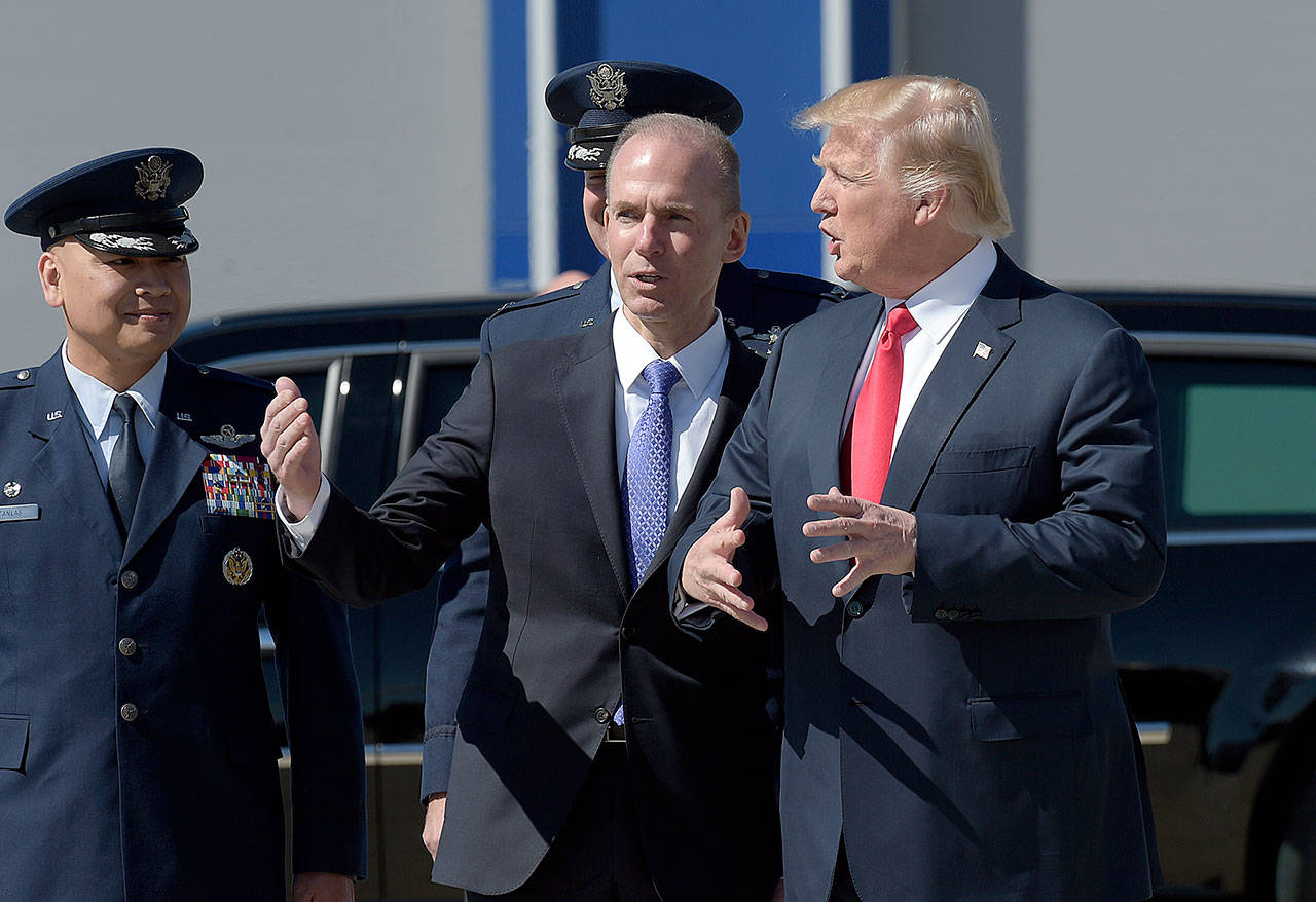 In this Feb. 17 photo, Boeing CEO Dennis Muilenburg talks with President Donald Trump at Charleston International Airport in North Charleston, South Carolina. (AP Photo / Susan Walsh)