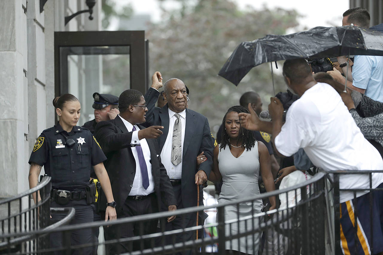 Bill Cosby gestures while exiting the Montgomery County Courthouse with his publicist Andrew Wyatt (second from left) after a mistrial was declared in his sexual assault trial in Norristown, Pennsylvania, on Saturday, June 17. Cosby’s trial ended without a verdict after jurors failed to reach a unanimous decision. (AP Photo/Matt Slocum)