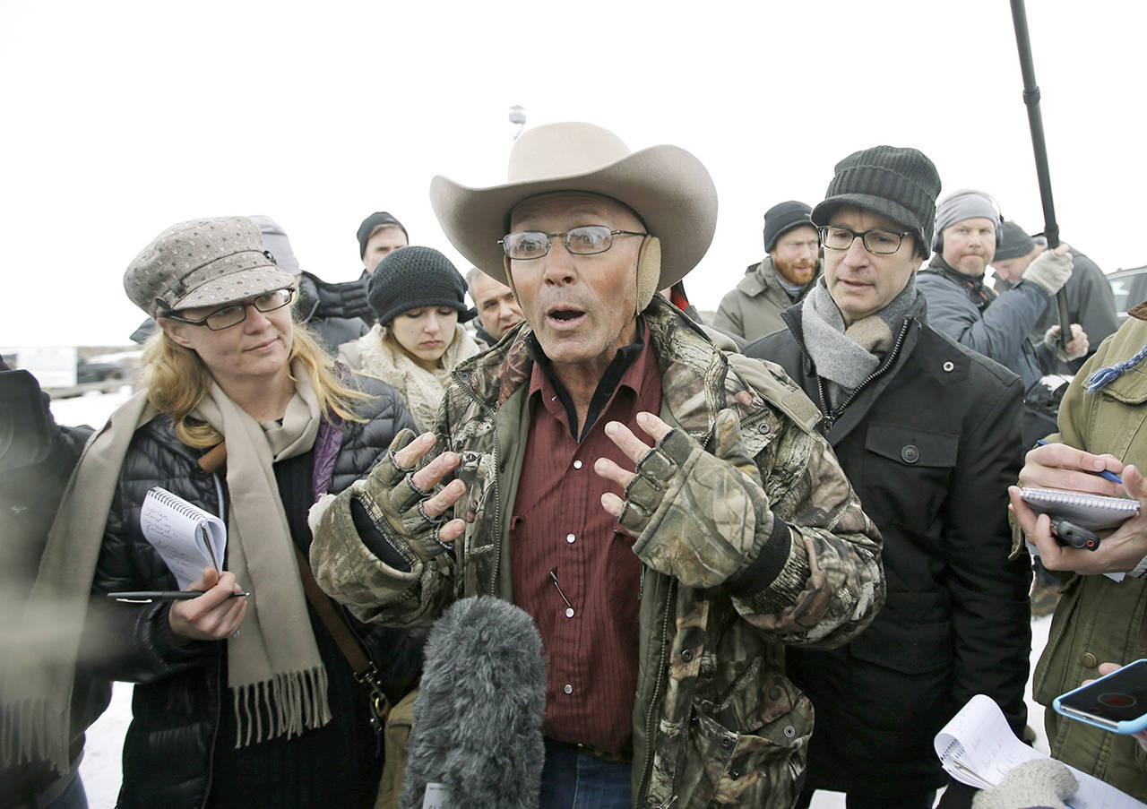 In this Jan. 5, 2016 photo, Robert “LaVoy” Finicum (center), a rancher from Arizona, talks to reporters at the Malheur National Wildlife Refuge near Burns, Oregon. (AP Photo/Rick Bowmer, File)