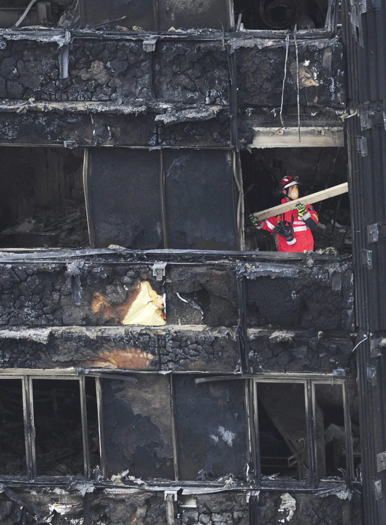 An Urban Search and Rescue officer from London Fire Brigade is seen inside the Grenfell Tower in west London after a fire engulfed the 24-story building on Saturday, June 17. (David Mirzoeff/PA via AP)
