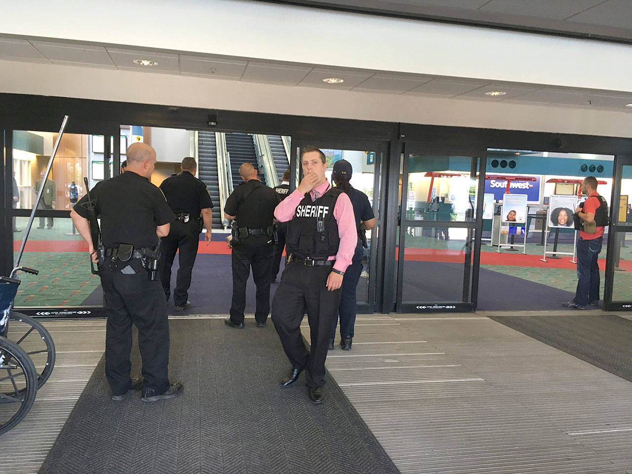 Police officers gather at a terminal at Bishop International Airport on Wednesday morning, June 21, in Flint, Michigan. (Dominic Adams/The Flint Journal-MLive.com via AP)