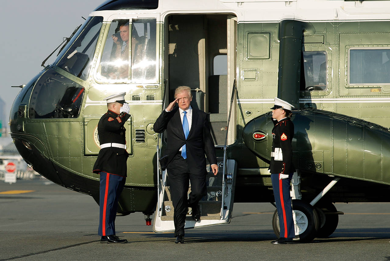 President Donald Trump salutes Sunday as he steps off Marine One before boarding Air Force One at Newark Liberty International Airport in Newark, New Jersey. (AP Photo/Patrick Semansky)