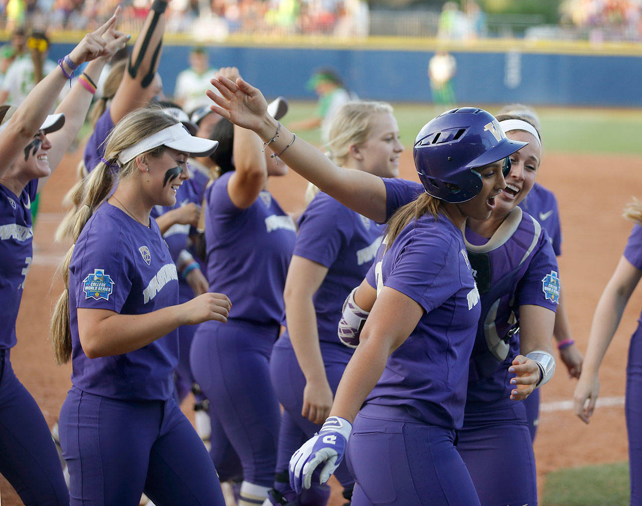 Washington’s Kirstyn Thomas (right front) celebrates with teammates after hitting a two-run home run in the seventh inning against Oregon in an NCAA Women’s College World Series game June 1 in Oklahoma City. (Bryan Terry/The Oklahoman via AP)