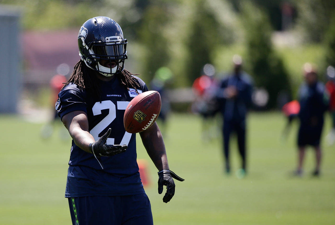Seahawks running back Eddie Lacy tosses the football during practice on June 2, 2017, in Renton. (AP Photo/Ted S. Warren)