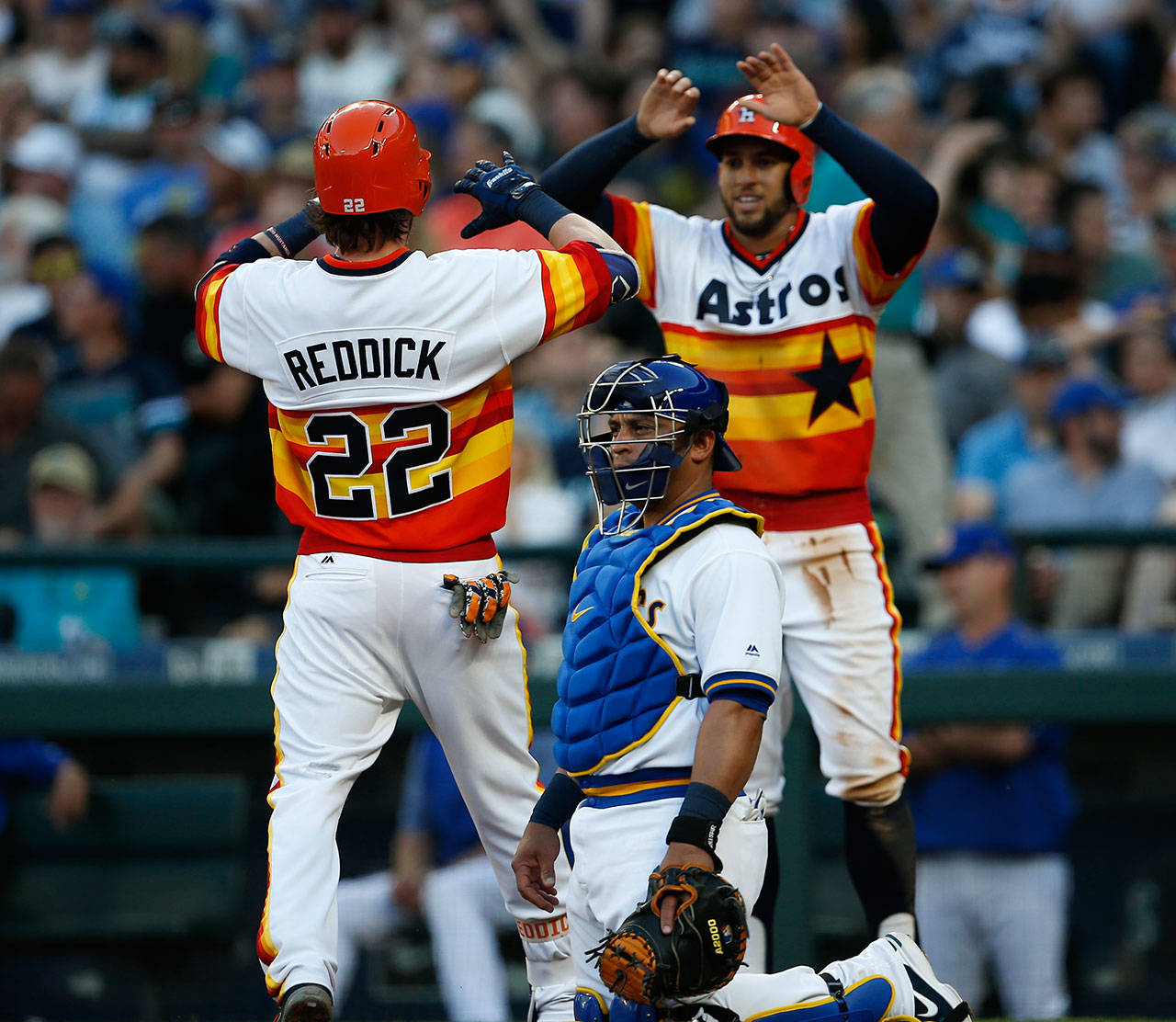 The Astros George Springer (right) celebrates with Josh Reddick (22) at home after Reddick’s home run as Mariners catcher Carlos Ruiz looks on during the third inning of a game June 24, 2017, in Seattle. (AP Photo/Jason Redmond)