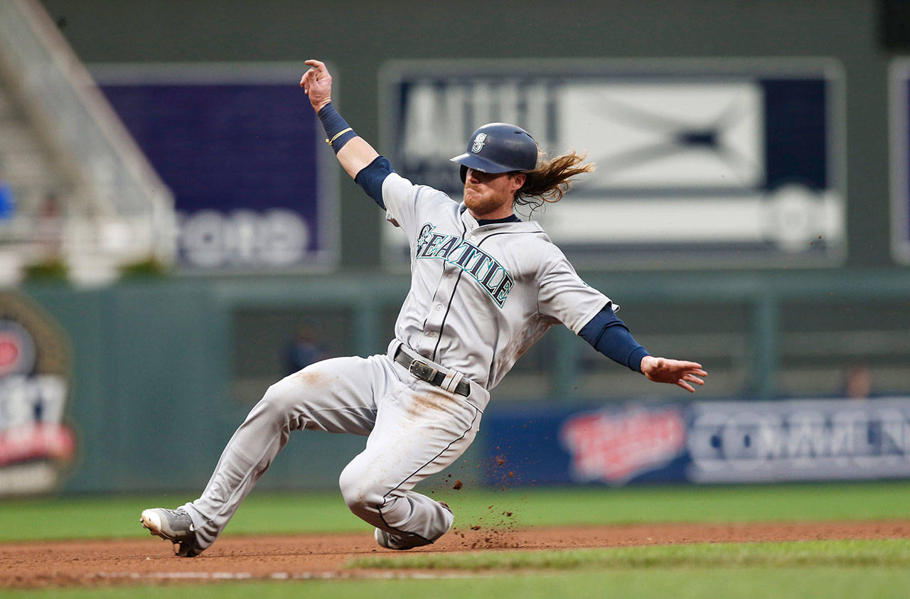 The Mariners’ Ben Gamel slides safely into third base as he advances from first on a hit by Mitch Haniger in the fourth inning of a game against the Twins on June 12, 2017, in Minneapolis. (AP Photo/Jim Mone)