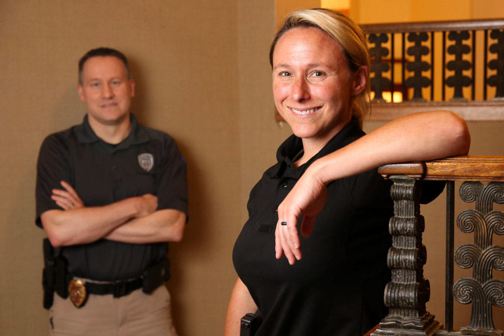 Ora Evans is a lateral transfer from the Vancouver, Washington police department. Her training officer, Sgt. Trevor Townsend, is behind her. (Kevin Clark / The Herald)
