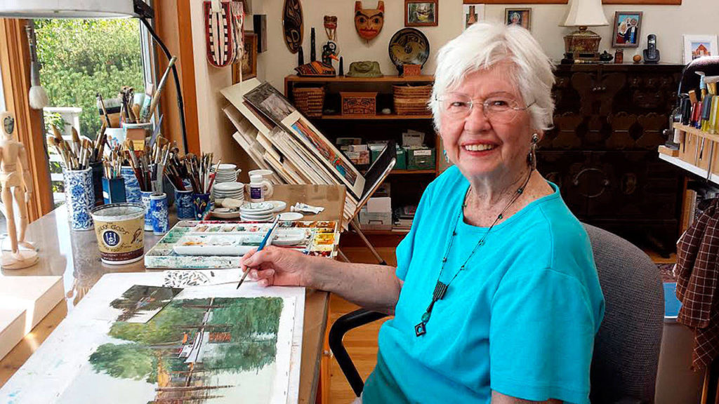 Pamela Harold poses while working on a new watercolor in her studio. She is the poster artist for the 60th anniversary Edmonds Arts Festival. Gale Fiege / Herald
