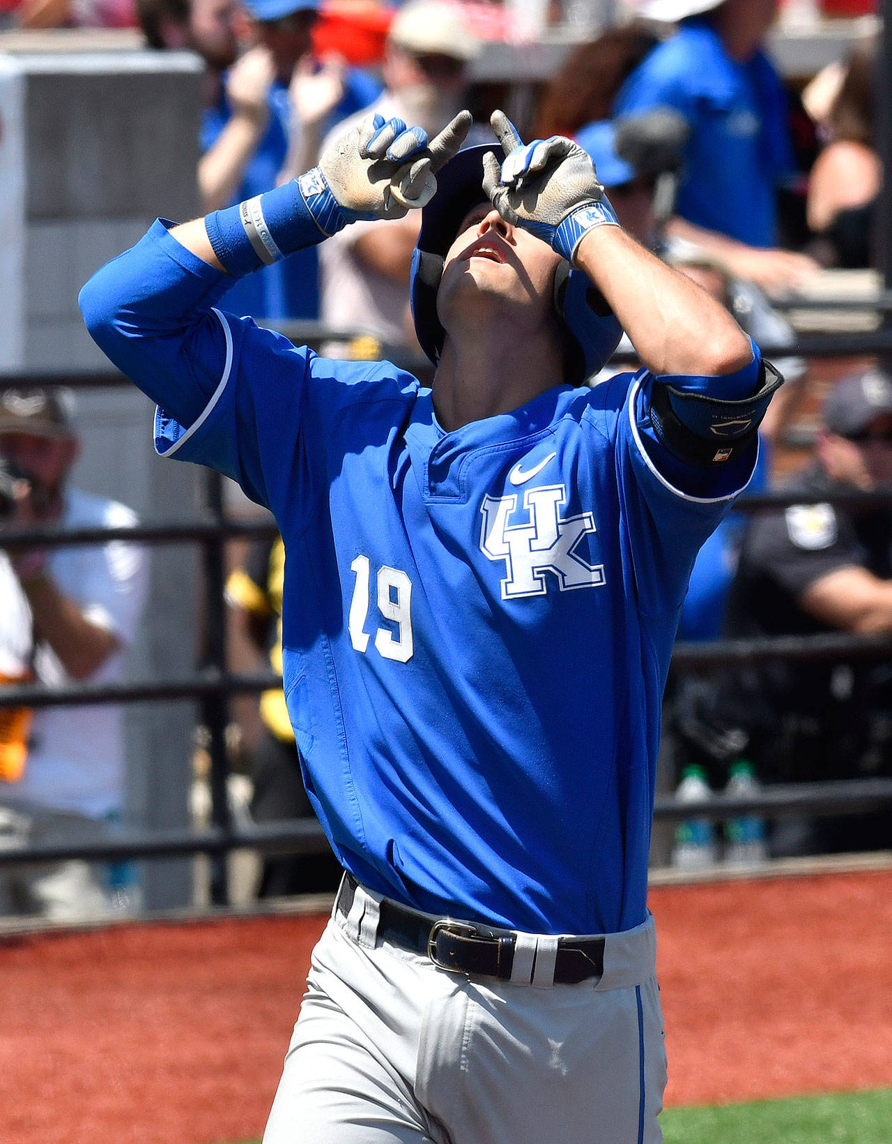 Kentucky’s Evan White points skyward as he crosses home plate after hitting a solo home run in the ninth inning during Friday in an NCAA Super Regional game against Louisville. (AP Photo / Timothy D. Easley)